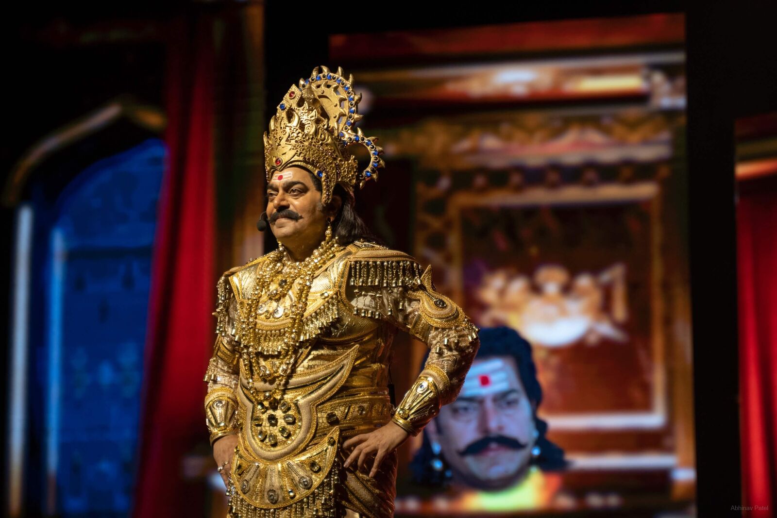 Gold-costumed performer standing on stage