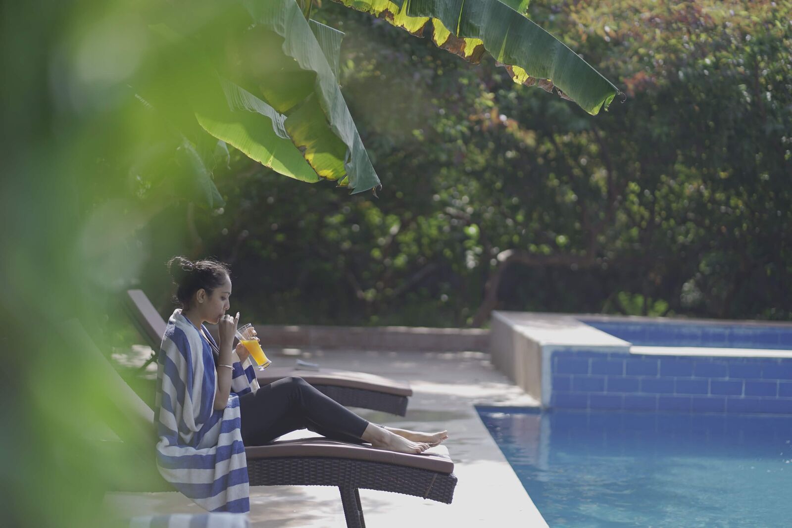 Guest enjoying a drink beside the pool