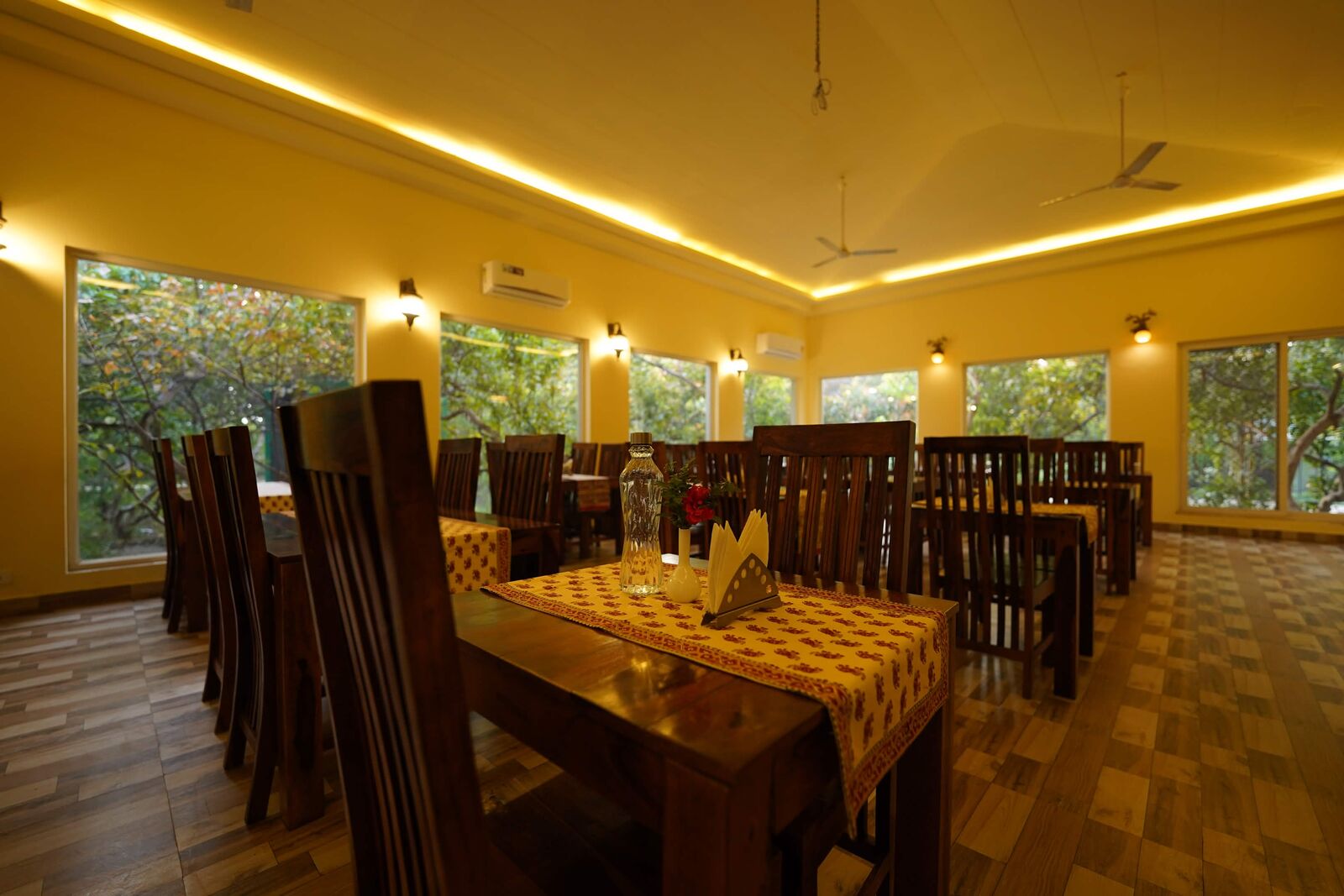 Set dining table in a window-lined resort restaurant