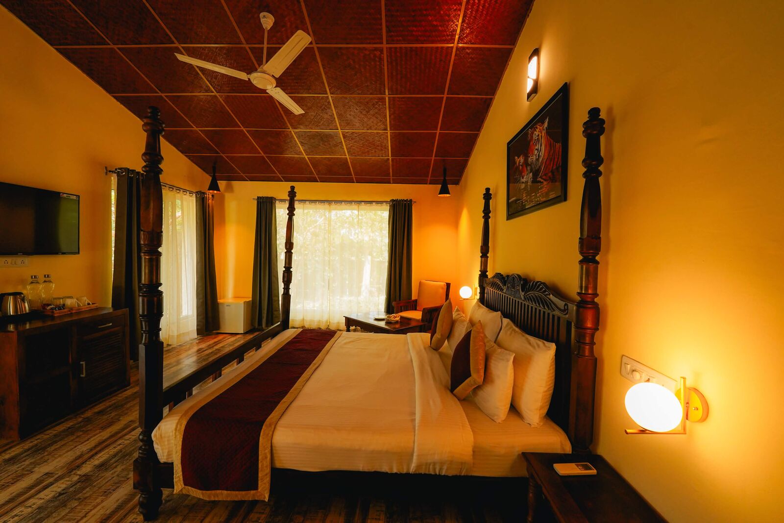 Warmly lit resort room with a four-poster bed