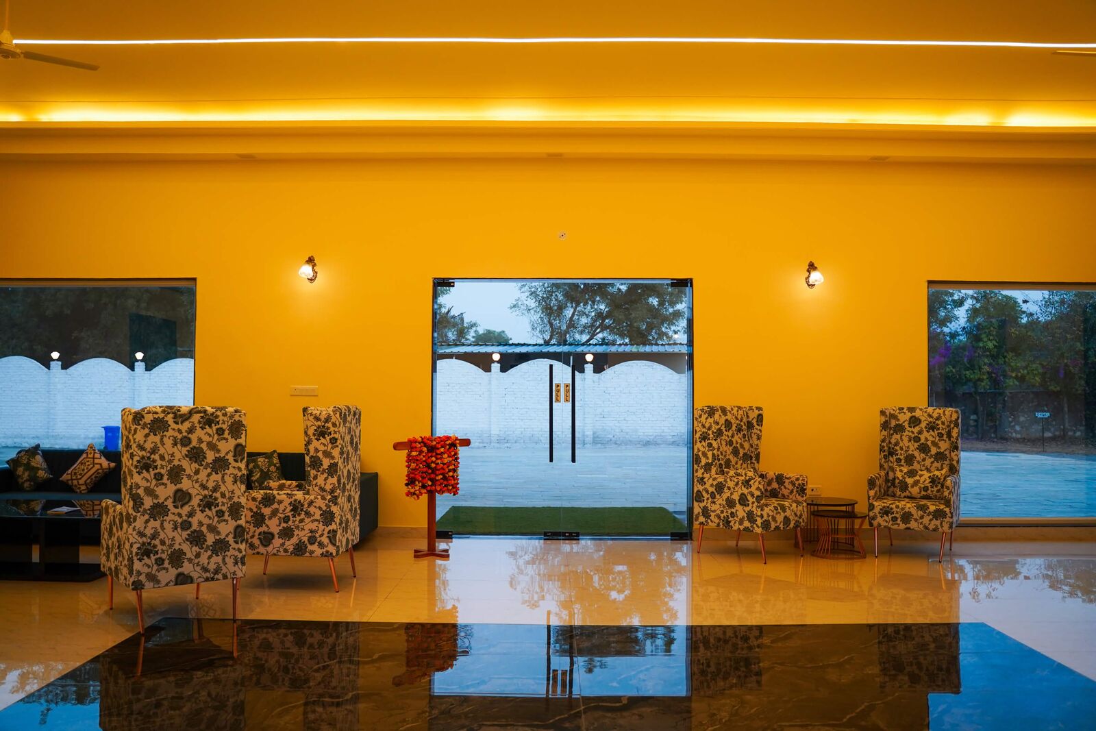 Resort lobby with floral armchairs and garden views