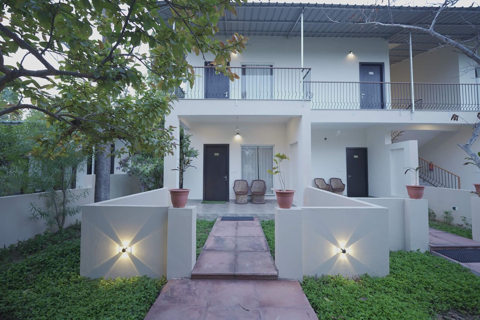 White resort villas viewed across a garden courtyard